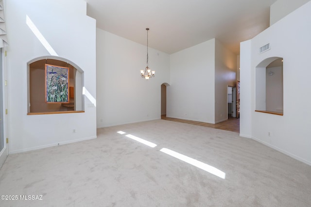 14085 E Copper Mesa Ct, Vail, AZ 85641 - carpeted empty room with a chandelier, high vaulted ceiling, and arched walkways