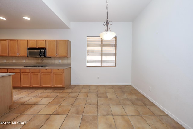 14085 E Copper Mesa Ct, Vail, AZ 85641 - kitchen with stainless steel microwave, light countertops, tasteful backsplash, hanging light fixtures, and light tile patterned floors