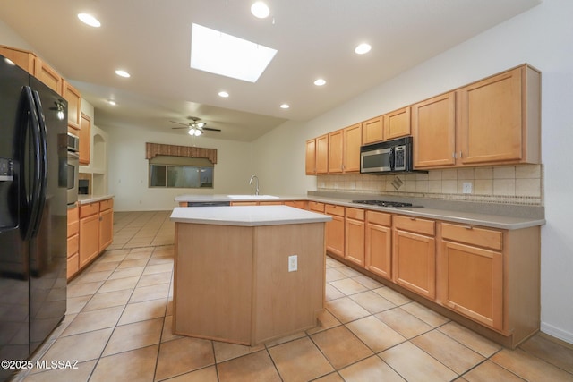 14085 E Copper Mesa Ct, Vail, AZ 85641 - kitchen featuring stainless steel appliances, a peninsula, decorative backsplash, a skylight, and light countertops