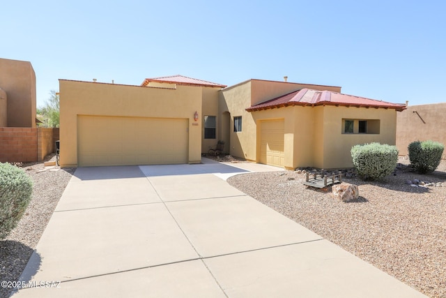 14085 E Copper Mesa Ct, Vail, AZ 85641 - view of front of home with stucco siding, a garage, a metal roof, and driveway