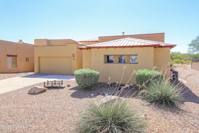 14085 E Copper Mesa Ct, Vail, AZ 85641 - pueblo-style house featuring a garage, concrete driveway, and stucco siding