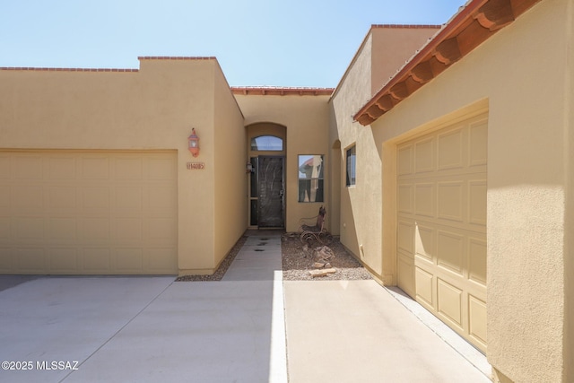 14085 E Copper Mesa Ct, Vail, AZ 85641 - doorway to property featuring stucco siding, a garage, a tile roof, and driveway