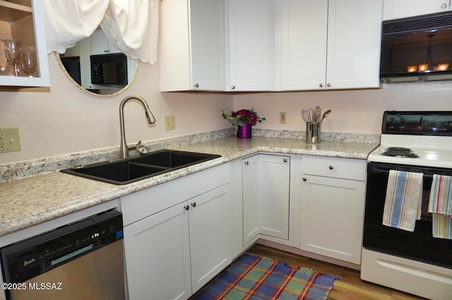 326 N Sage St, Pearce, AZ 85625 - kitchen featuring black microwave, range with electric cooktop, dishwasher, white cabinetry, and light countertops