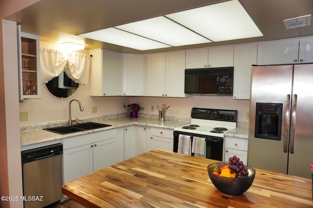 326 N Sage St, Pearce, AZ 85625 - kitchen with stainless steel appliances, wood counters, and white cabinets