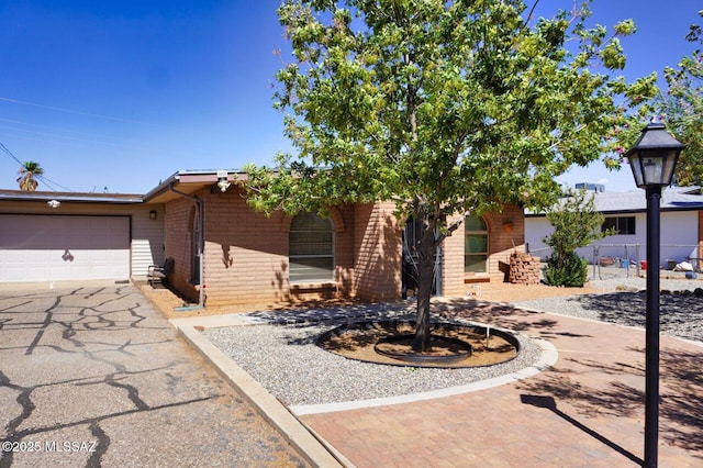 326 N Sage St, Pearce, AZ 85625 - view of front of property featuring driveway, brick siding, and an attached garage