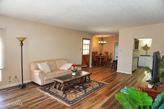 326 N Sage St, Pearce, AZ 85625 - living room with a chandelier, wood finished floors, and a textured ceiling