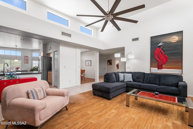 14092 E Placita Mochuelo, Vail, AZ 85641 - living room with ceiling fan, light wood-type flooring, and a towering ceiling