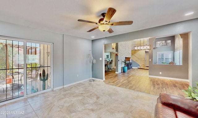 8942 N Ferber Ct, Tucson, AZ 85742 - living area with a ceiling fan, healthy amount of natural light, stairs, and recessed lighting