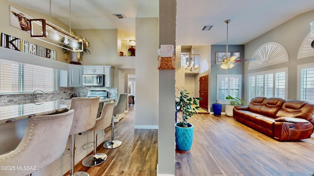 8942 N Ferber Ct, Tucson, AZ 85742 - living room featuring a high ceiling, wood finished floors, and ceiling fan