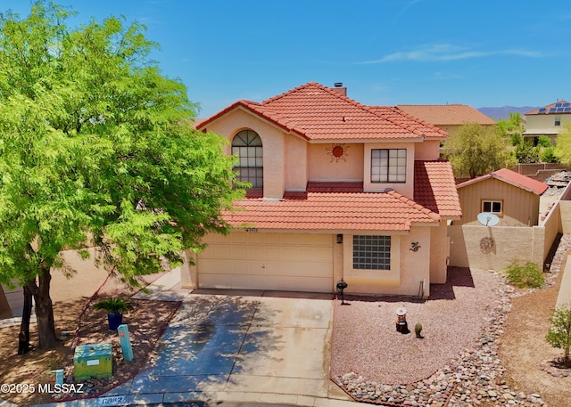 8942 N Ferber Ct, Tucson, AZ 85742 - mediterranean / spanish home with a tiled roof, stucco siding, driveway, an attached garage, and a chimney