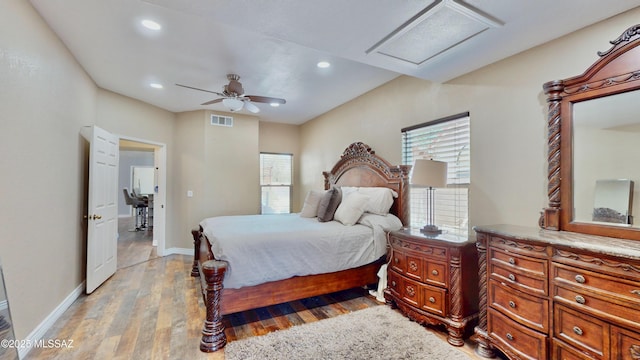 8942 N Ferber Ct, Tucson, AZ 85742 - bedroom with attic access, multiple windows, light wood-style floors, recessed lighting, and a ceiling fan