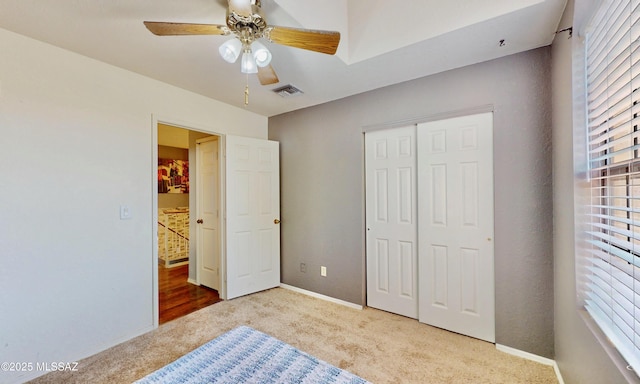 8942 N Ferber Ct, Tucson, AZ 85742 - unfurnished bedroom with carpet, multiple windows, a closet, and ceiling fan