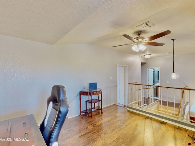 8942 N Ferber Ct, Tucson, AZ 85742 - office with wood finished floors, vaulted ceiling, a ceiling fan, and a textured ceiling