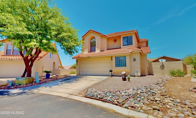 8942 N Ferber Ct, Tucson, AZ 85742 - mediterranean / spanish-style house featuring a garage, a tile roof, stucco siding, and driveway