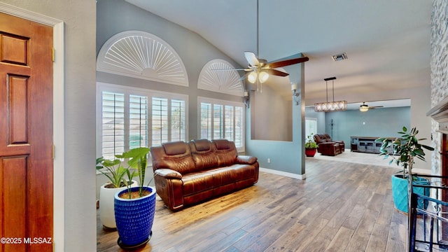 8942 N Ferber Ct, Tucson, AZ 85742 - living area with a ceiling fan, lofted ceiling, wood finished floors, and a glass covered fireplace