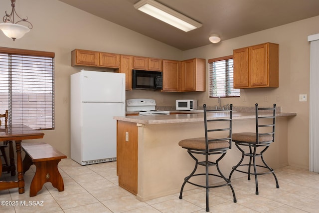 5442 W Cochie Springs St, Marana, AZ 85658 - kitchen with white appliances, lofted ceiling, a peninsula, light countertops, and a breakfast bar area