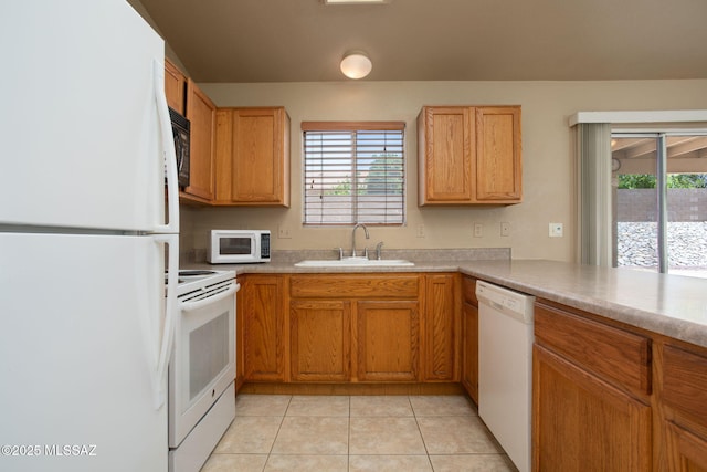 5442 W Cochie Springs St, Marana, AZ 85658 - kitchen with white appliances, plenty of natural light, light tile patterned floors, and light countertops