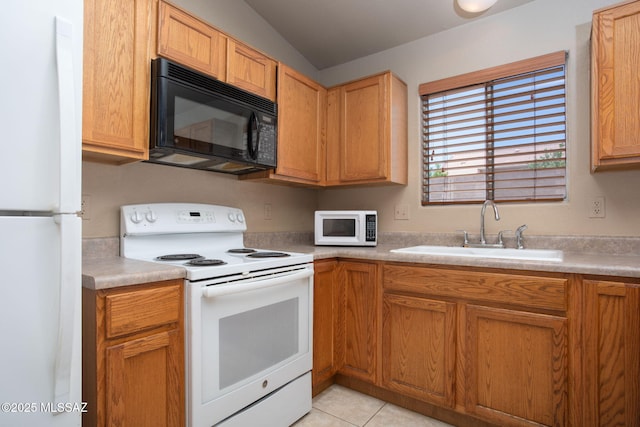 5442 W Cochie Springs St, Marana, AZ 85658 - kitchen with white appliances, light countertops, vaulted ceiling, and light tile patterned floors
