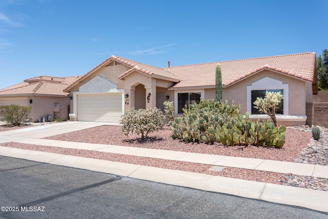 5442 W Cochie Springs St, Marana, AZ 85658 - single story home featuring a tiled roof, stucco siding, a garage, and driveway