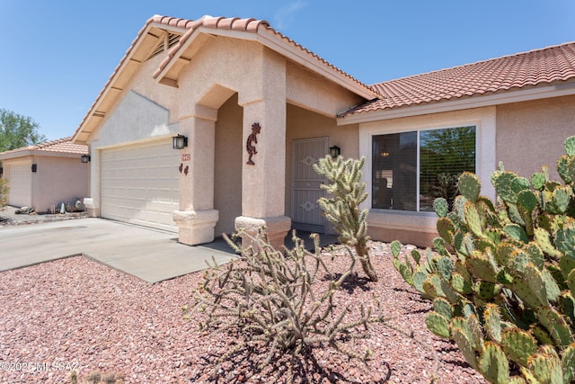 5442 W Cochie Springs St, Marana, AZ 85658 - view of front facade featuring a tiled roof, an attached garage, stucco siding, and driveway