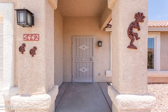 5442 W Cochie Springs St, Marana, AZ 85658 - view of exterior entry featuring stucco siding and a tiled roof