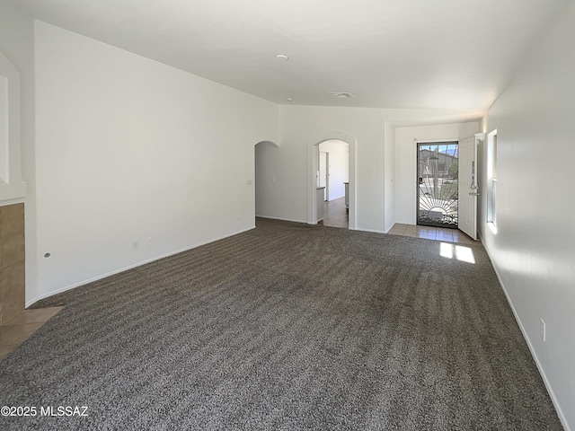 8758 E Mountain Spring Dr, Tucson, AZ 85747 - unfurnished living room with carpet flooring and arched walkways