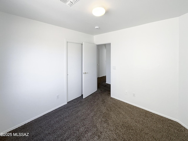 8758 E Mountain Spring Dr, Tucson, AZ 85747 - unfurnished bedroom with dark carpet and a closet
