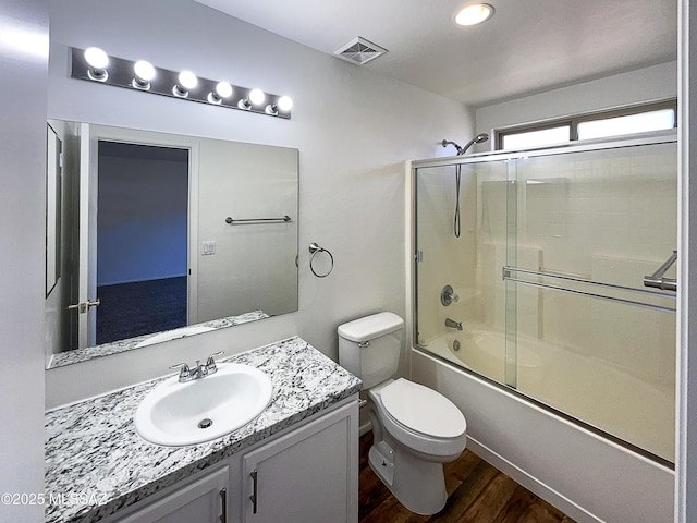 8758 E Mountain Spring Dr, Tucson, AZ 85747 - full bathroom featuring wood finished floors, vanity, and combined bath / shower with glass door