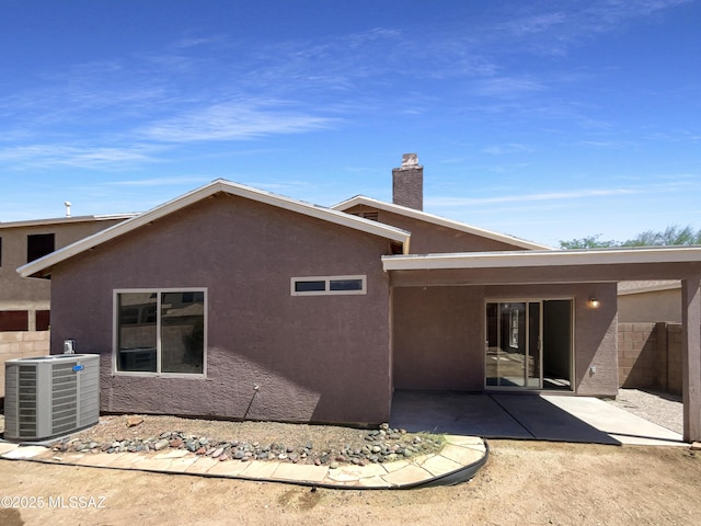 8758 E Mountain Spring Dr, Tucson, AZ 85747 - rear view of house with stucco siding, a patio area, and a chimney