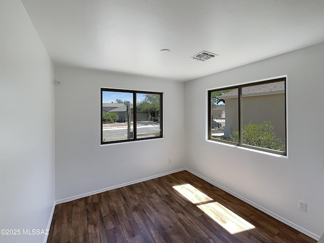 8758 E Mountain Spring Dr, Tucson, AZ 85747 - empty room with healthy amount of natural light and wood finished floors