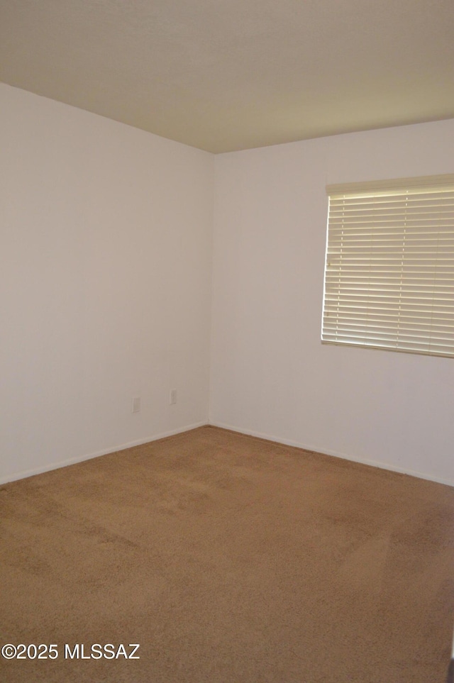 1809 E Miles St, Tucson, AZ 85719 - carpeted empty room featuring baseboards
