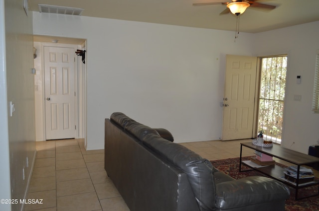 1809 E Miles St, Tucson, AZ 85719 - living room with light tile patterned floors, a ceiling fan, and healthy amount of natural light