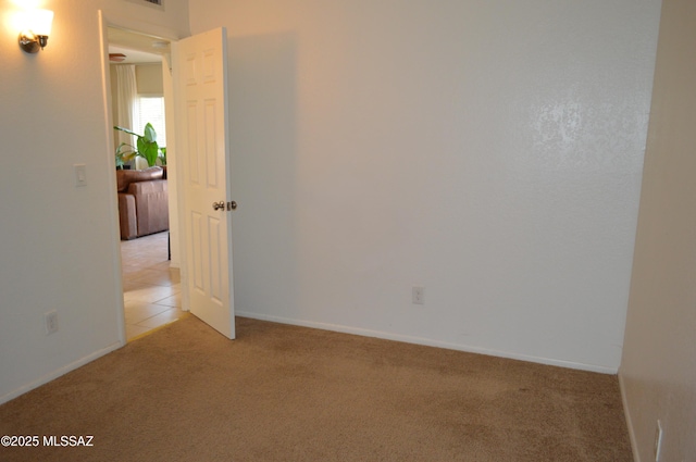 1809 E Miles St, Tucson, AZ 85719 - unfurnished room featuring light colored carpet and baseboards