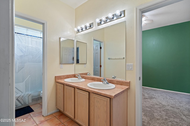 11120 E Mountain Gate Pl, Tucson, AZ 85749 - full bath featuring double vanity, a ceiling fan, and tile patterned floors