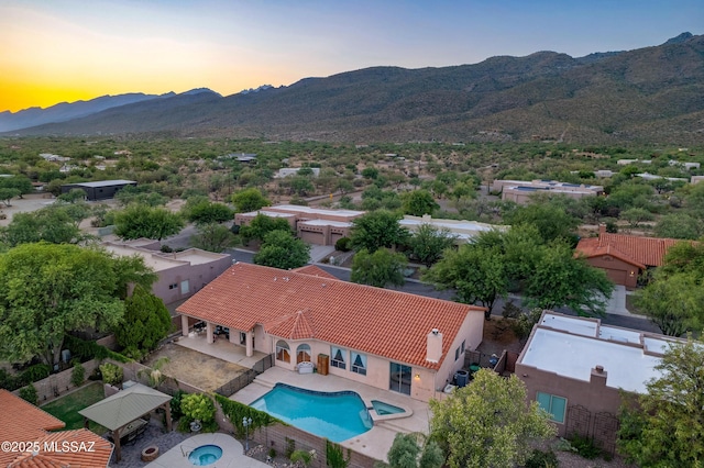 11120 E Mountain Gate Pl, Tucson, AZ 85749 - aerial view at dusk of a mountain view and view of pool area