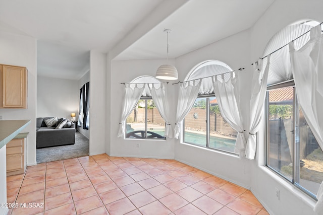 11120 E Mountain Gate Pl, Tucson, AZ 85749 - unfurnished dining area with plenty of natural light, light tile patterned floors, and light carpet