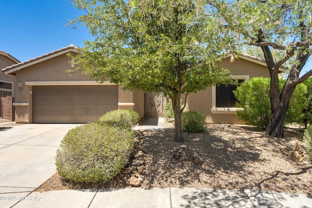 9407 E Greek Sage Way, Vail, AZ 85641 - obstructed view of property featuring stucco siding, a garage, and concrete driveway