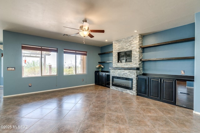 9407 E Greek Sage Way, Vail, AZ 85641 - unfurnished living room with a ceiling fan, a stone fireplace, and tile patterned flooring