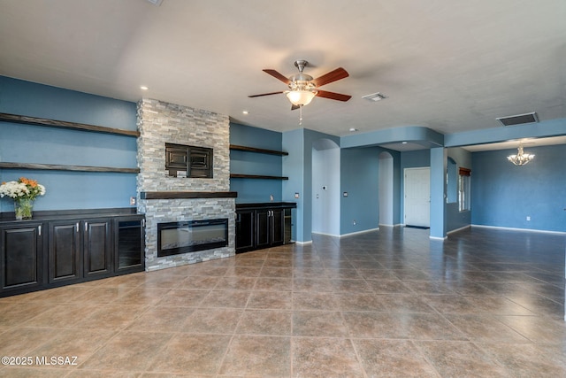 9407 E Greek Sage Way, Vail, AZ 85641 - unfurnished living room with a ceiling fan, arched walkways, a fireplace, a chandelier, and recessed lighting