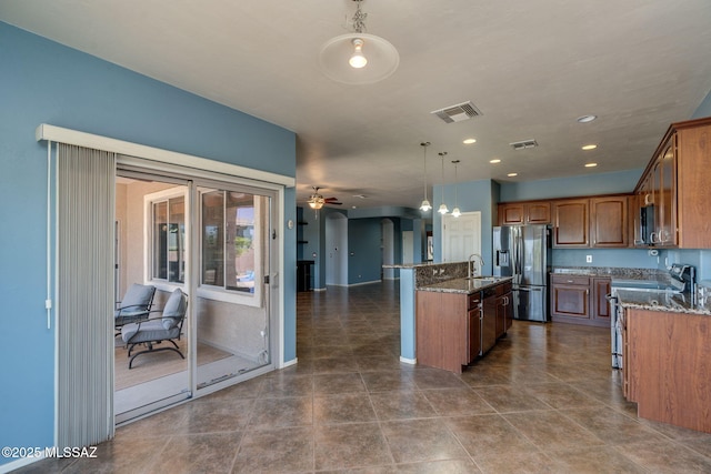 9407 E Greek Sage Way, Vail, AZ 85641 - kitchen with stainless steel appliances, a kitchen island with sink, dark stone countertops, hanging light fixtures, and ceiling fan