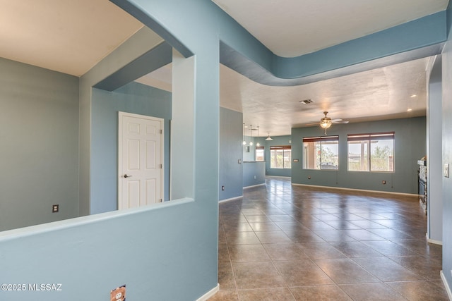9407 E Greek Sage Way, Vail, AZ 85641 - unfurnished living room with a ceiling fan, arched walkways, and tile patterned floors