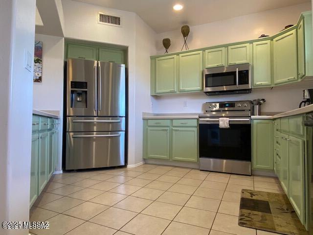 655 W Vistoso Highlands Dr Unit 235, Oro Valley, AZ 85755 - kitchen featuring green cabinets, appliances with stainless steel finishes, light tile patterned floors, light countertops, and recessed lighting