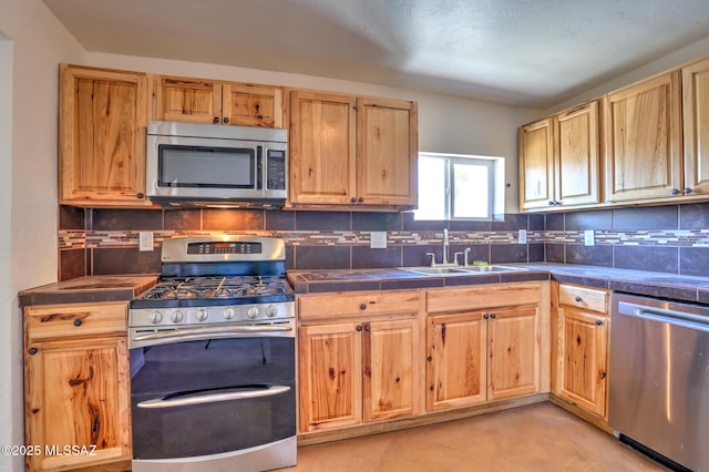 1125 W Huron St, Tucson, AZ 85745 - kitchen with appliances with stainless steel finishes, tile counters, backsplash, and light brown cabinets