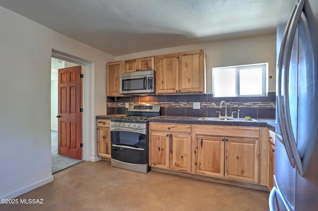 1125 W Huron St, Tucson, AZ 85745 - kitchen featuring stainless steel appliances, decorative backsplash, and tile counters
