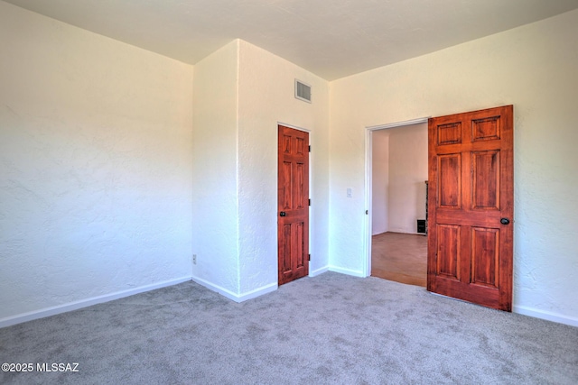 1125 W Huron St, Tucson, AZ 85745 - carpeted spare room featuring a textured wall and baseboards