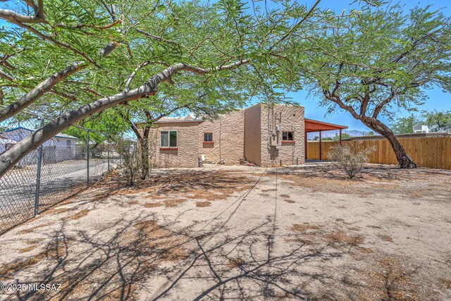 1125 W Huron St, Tucson, AZ 85745 - back of house with a fenced backyard and stucco siding