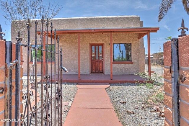 1125 W Huron St, Tucson, AZ 85745 - entrance to property featuring stucco siding and covered porch
