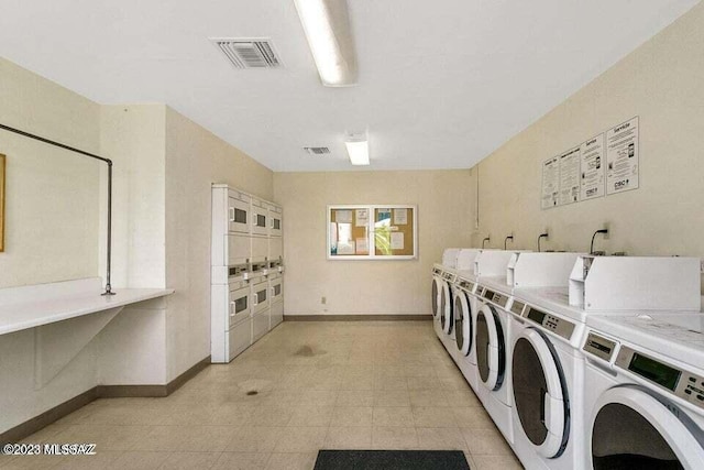 8450 E Old Spanish Trl Unit 152, Tucson, AZ 85710 - communal laundry room with washer and clothes dryer, stacked washer / drying machine, and light floors