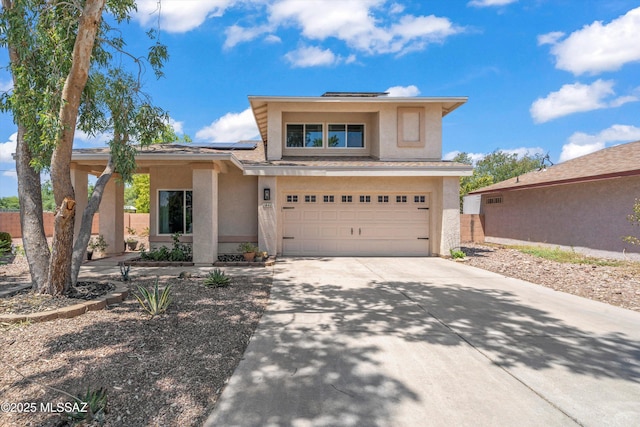 1441 N Calle De Durazo, Tucson, AZ 85715 - view of front facade featuring stucco siding, a garage, roof mounted solar panels, and driveway