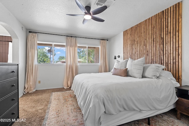 1441 N Calle De Durazo, Tucson, AZ 85715 - carpeted bedroom featuring arched walkways, a textured ceiling, multiple windows, and a ceiling fan